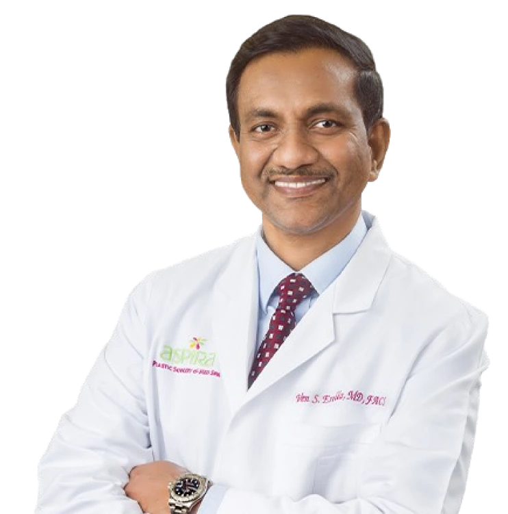 Dr. Venkata Erella in white lab coat and burgundy patterned tie, smiling at camera