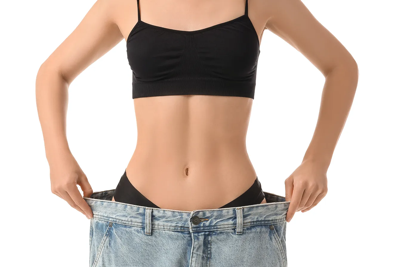 Woman showing a slimmer abdominal contour after stomach fat reduction.